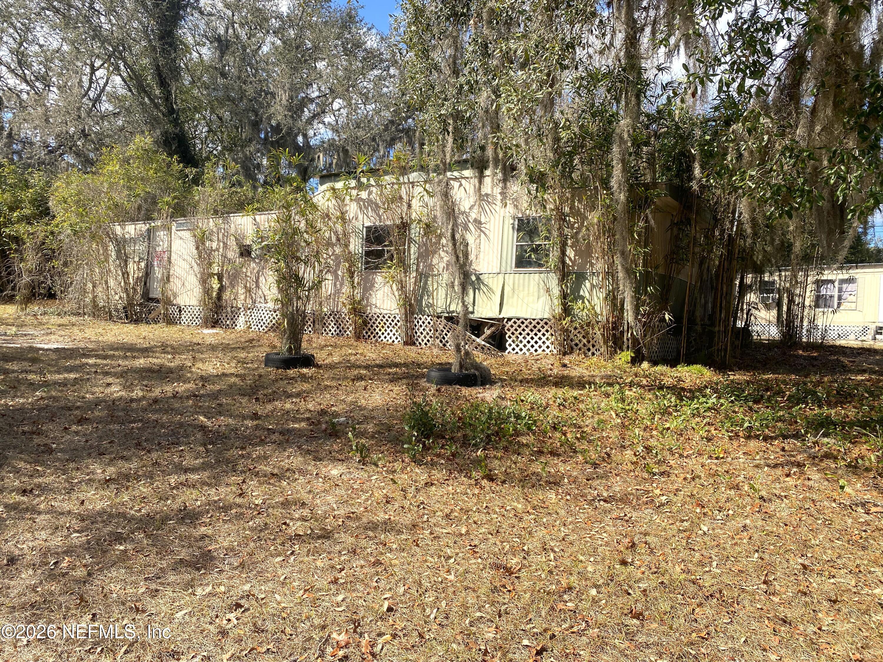 127 Riverside Trail Satsuma, FL 32189 - Photo 6 of 10 a view of outdoor space with deck and trees