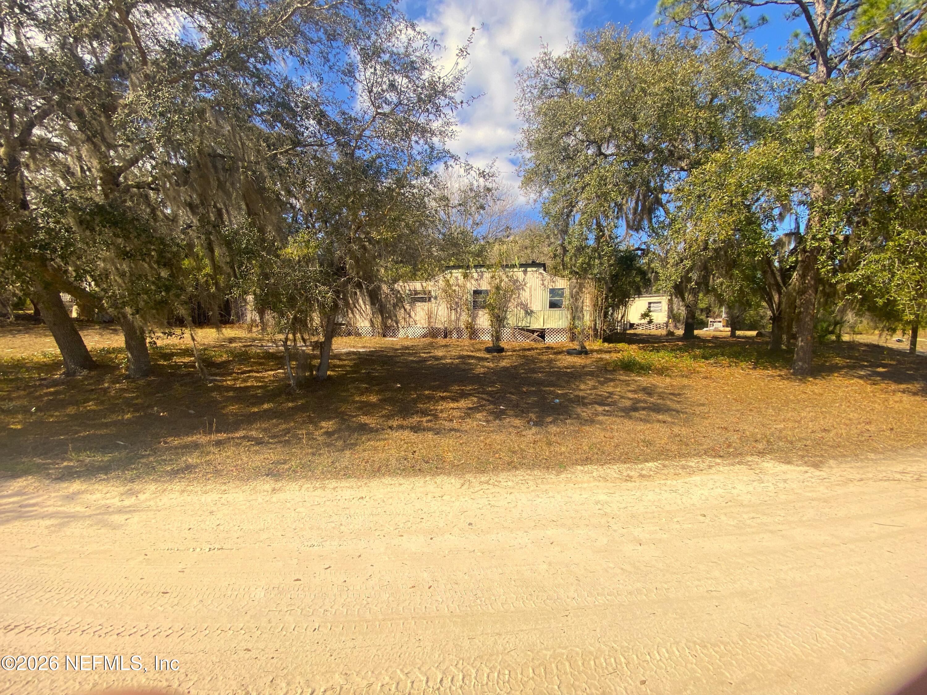 127 Riverside Trail Satsuma, FL 32189 - Photo 8 of 10 a view of a swimming pool with an outdoor space and seating area