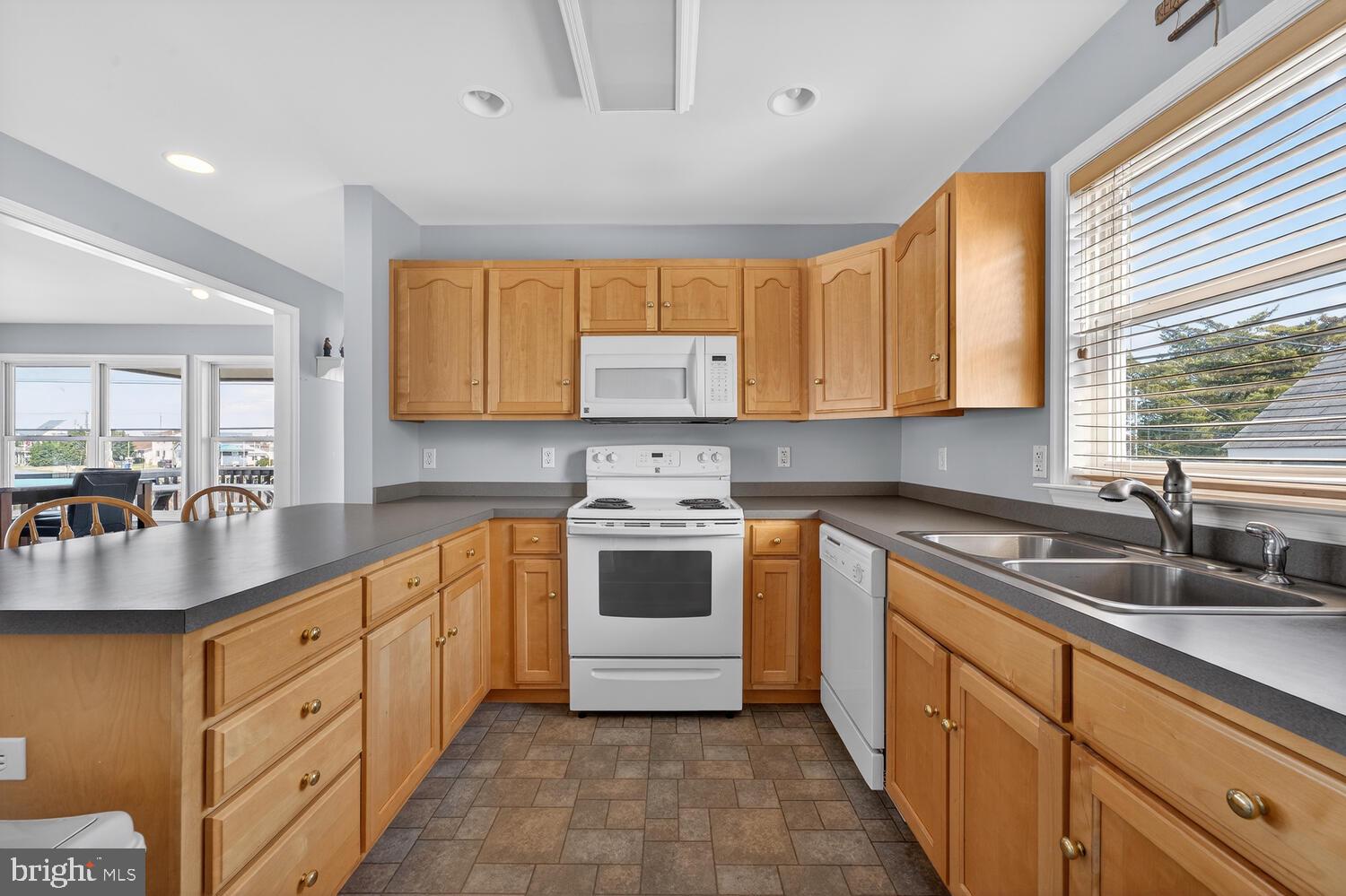 4376 South Bowers Road Milford, DE 19963 - Photo 23 of 46 a kitchen with stainless steel appliances granite countertop a sink stove and cabinets