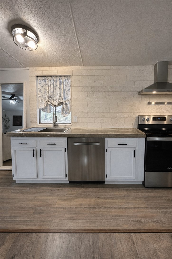 7031 Red Rock Road Franklin, TX 77856 - Photo 6 of 17 a large kitchen with stainless steel appliances granite countertop a stove a sink and a microwave