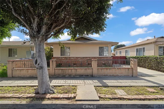 front view of a house with a tree