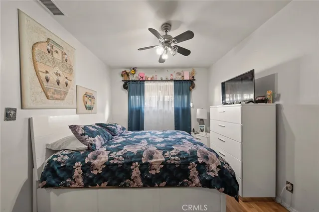 a bed room with a bed and a refrigerator