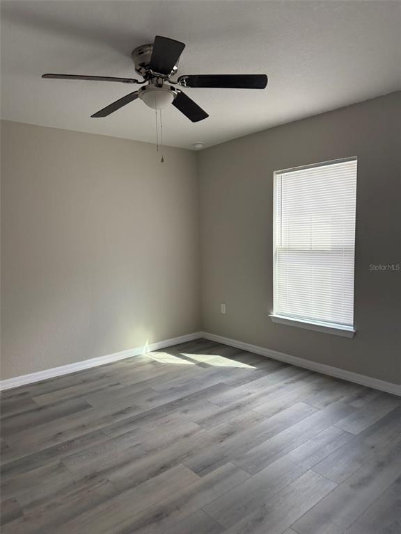 9539 North Travis Drive, Unit B Citrus Springs, FL 34434 - Photo 6 of 11 a view of an empty room with wooden floor and a window