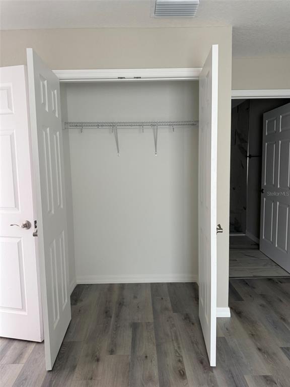 9539 North Travis Drive, Unit B Citrus Springs, FL 34434 - Photo 9 of 11 an empty room with wooden floor