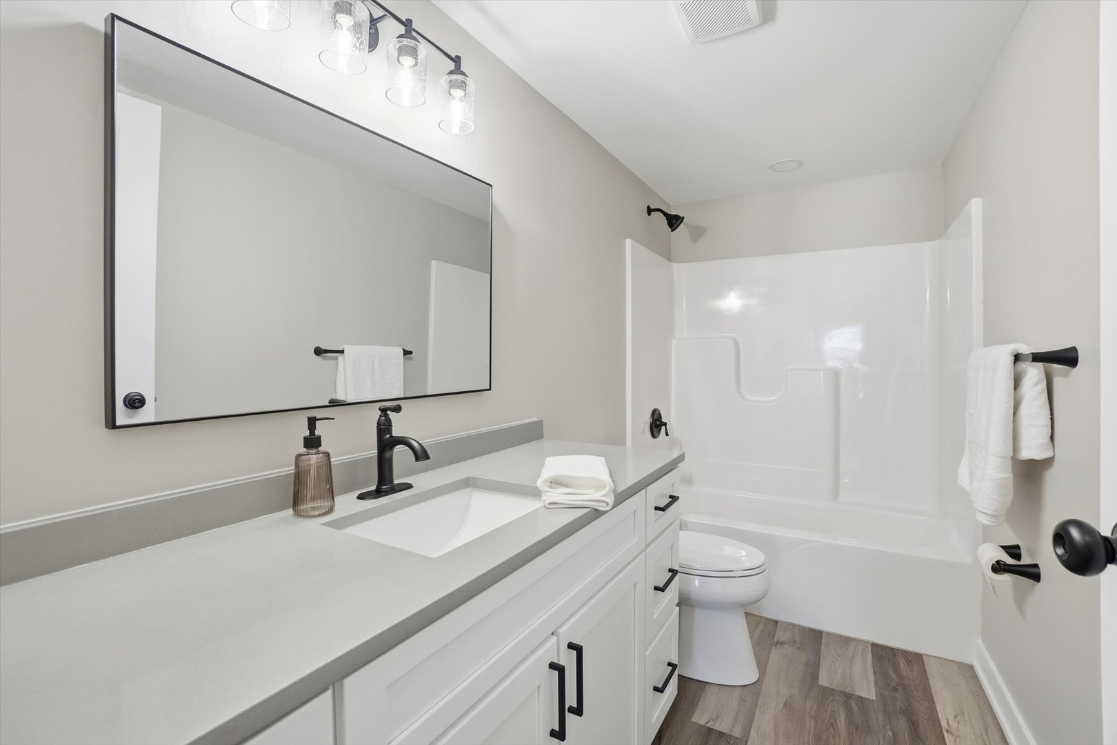 1313 Elizabeth Street Joliet, IL 60435 - Photo 11 of 27 a bathroom with a granite countertop sink a toilet and a large mirror