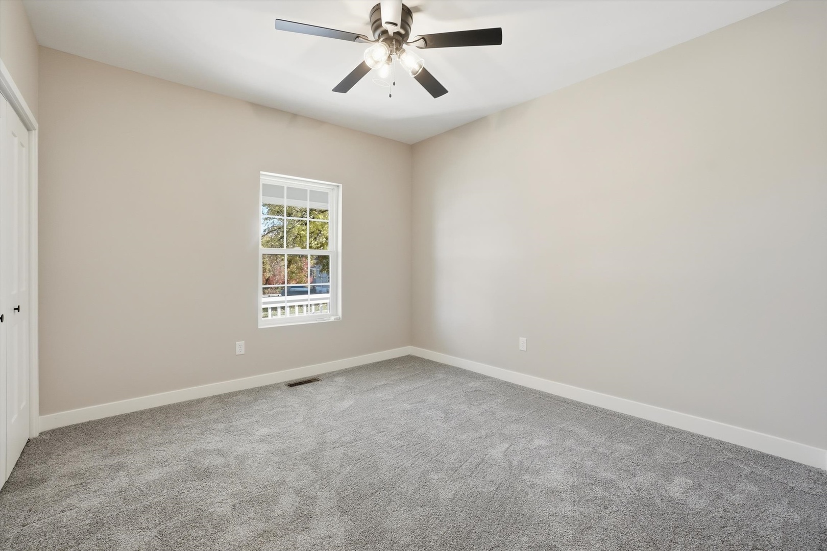 1313 Elizabeth Street Joliet, IL 60435 - Photo 15 of 27 an empty room with windows and fan