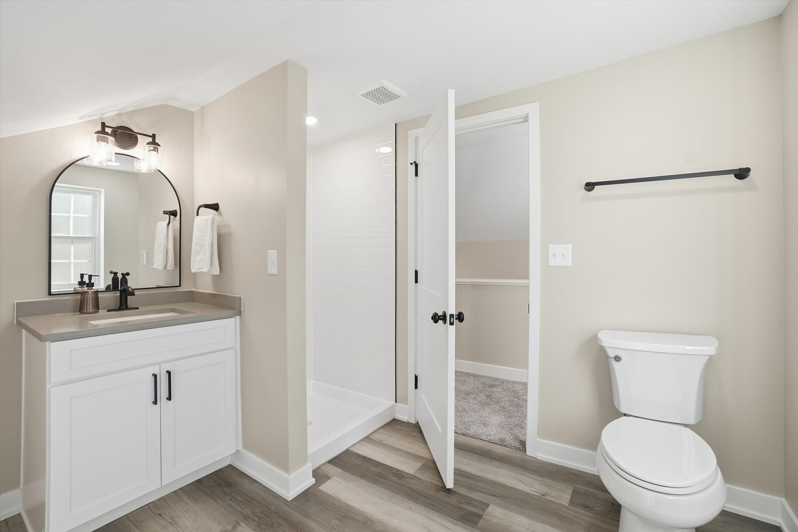 1313 Elizabeth Street Joliet, IL 60435 - Photo 16 of 27 a bathroom with a toilet a sink and a mirror