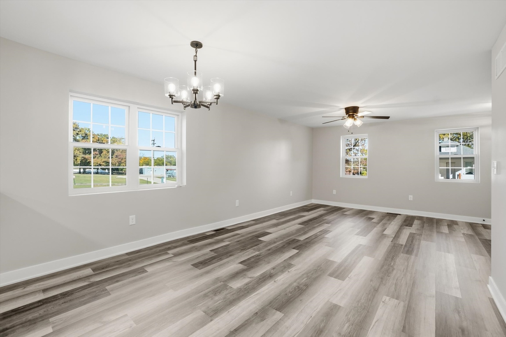 1313 Elizabeth Street Joliet, IL 60435 - Photo 8 of 27 wooden floor in an empty room with a window