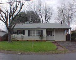 1011 Layton Road, Unit 1 Redding, CA 96002 - Photo 1 of 1 a front view of a house with a garden and trees