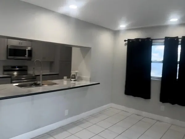 a kitchen with a sink and refrigerator