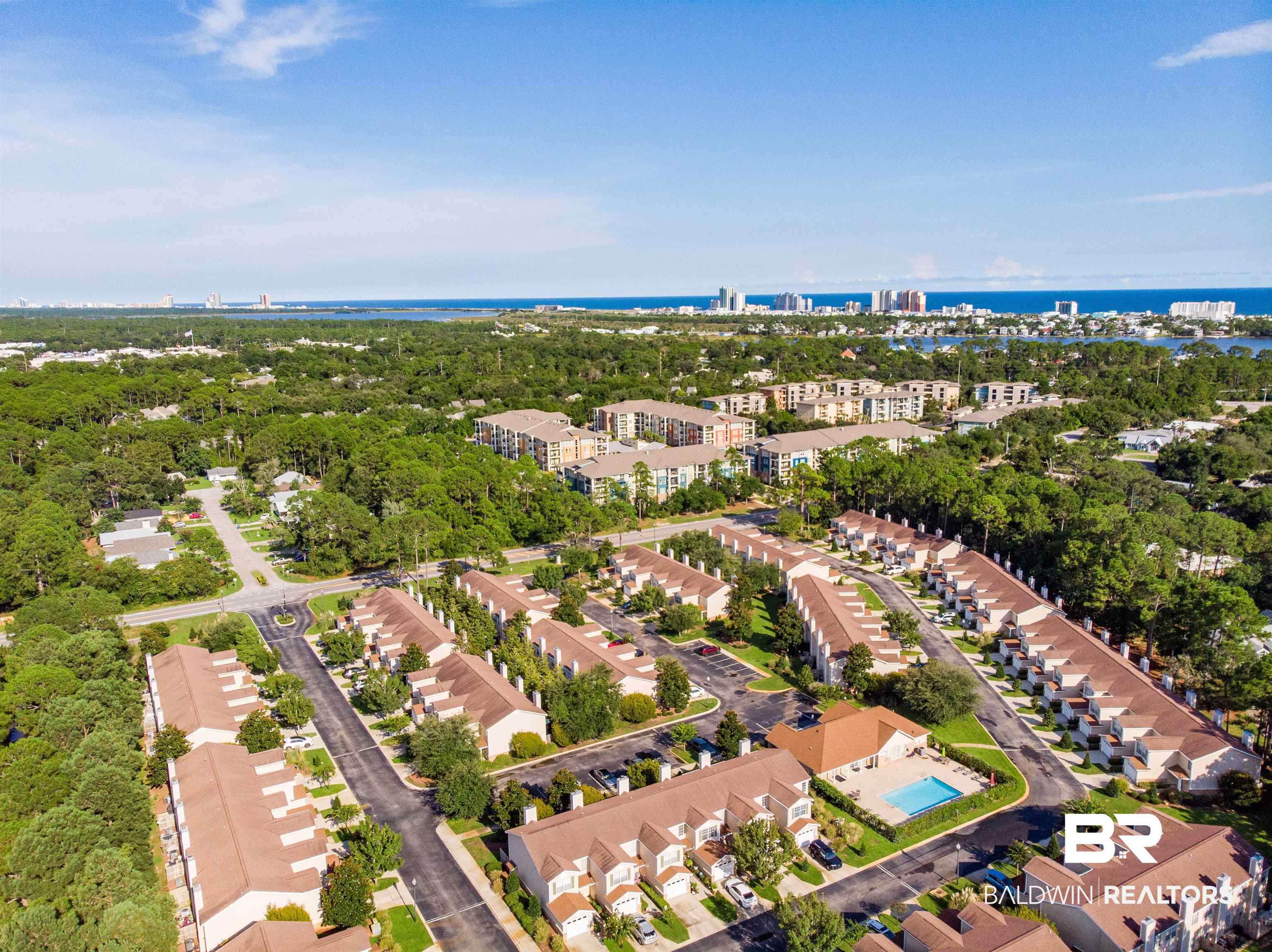 1517 Regency Road, Unit 142 Gulf Shores, AL 36542 - Photo 43 of 49 View of urban area with a nearby body of water and a tree filled landscape
