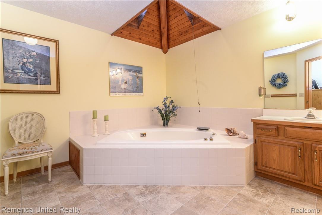 12264 Raelyn Hills Drive Perry, MI 48872 - Photo 26 of 46 Master Bath w/ Sky Light and Jetted Tub