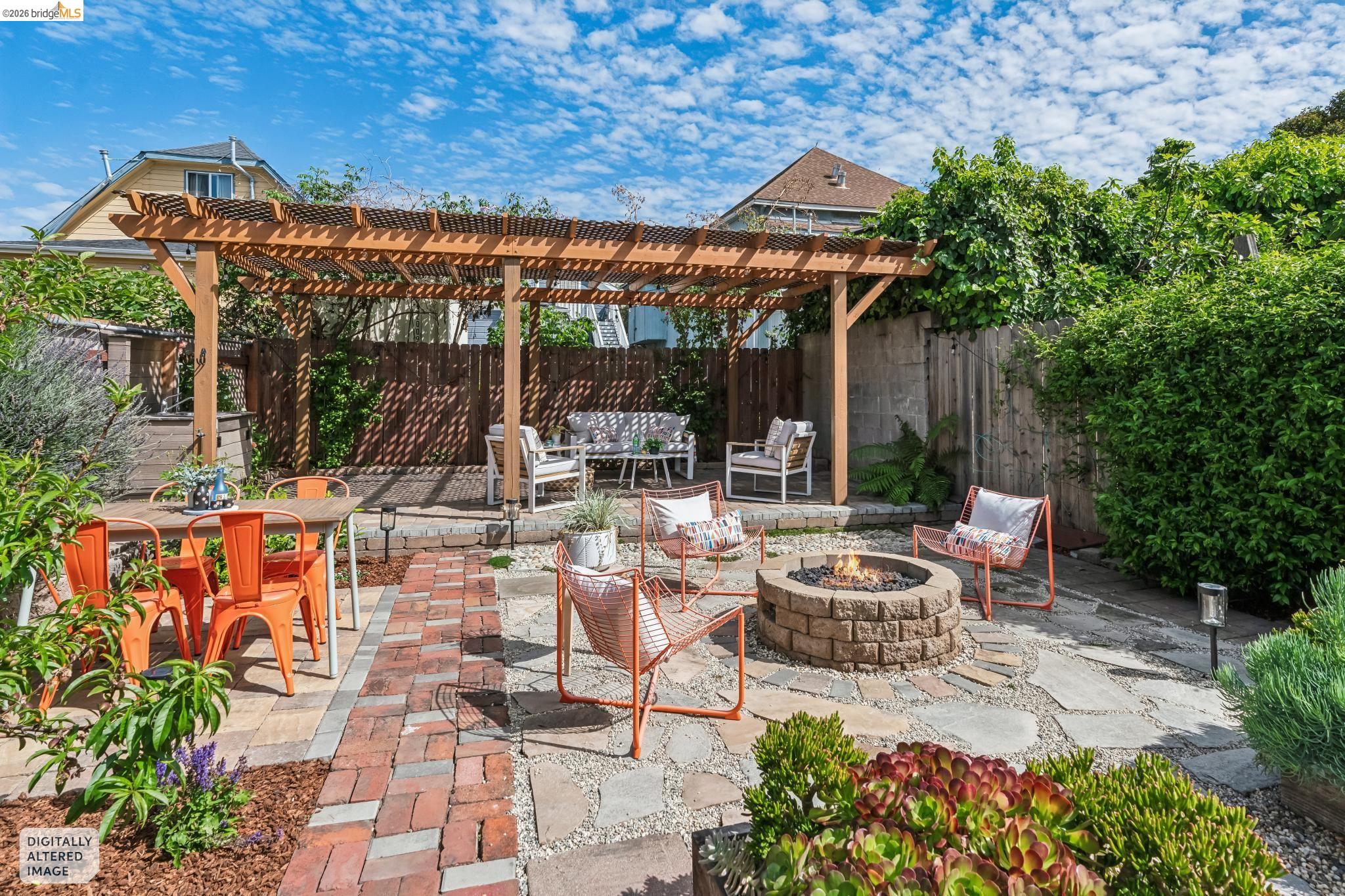 2010 Filbert Street Oakland, CA 94607 - Photo 12 of 50 Fenced backyard with a pergola, a patio area, an outdoor fire pit, and outdoor dining area