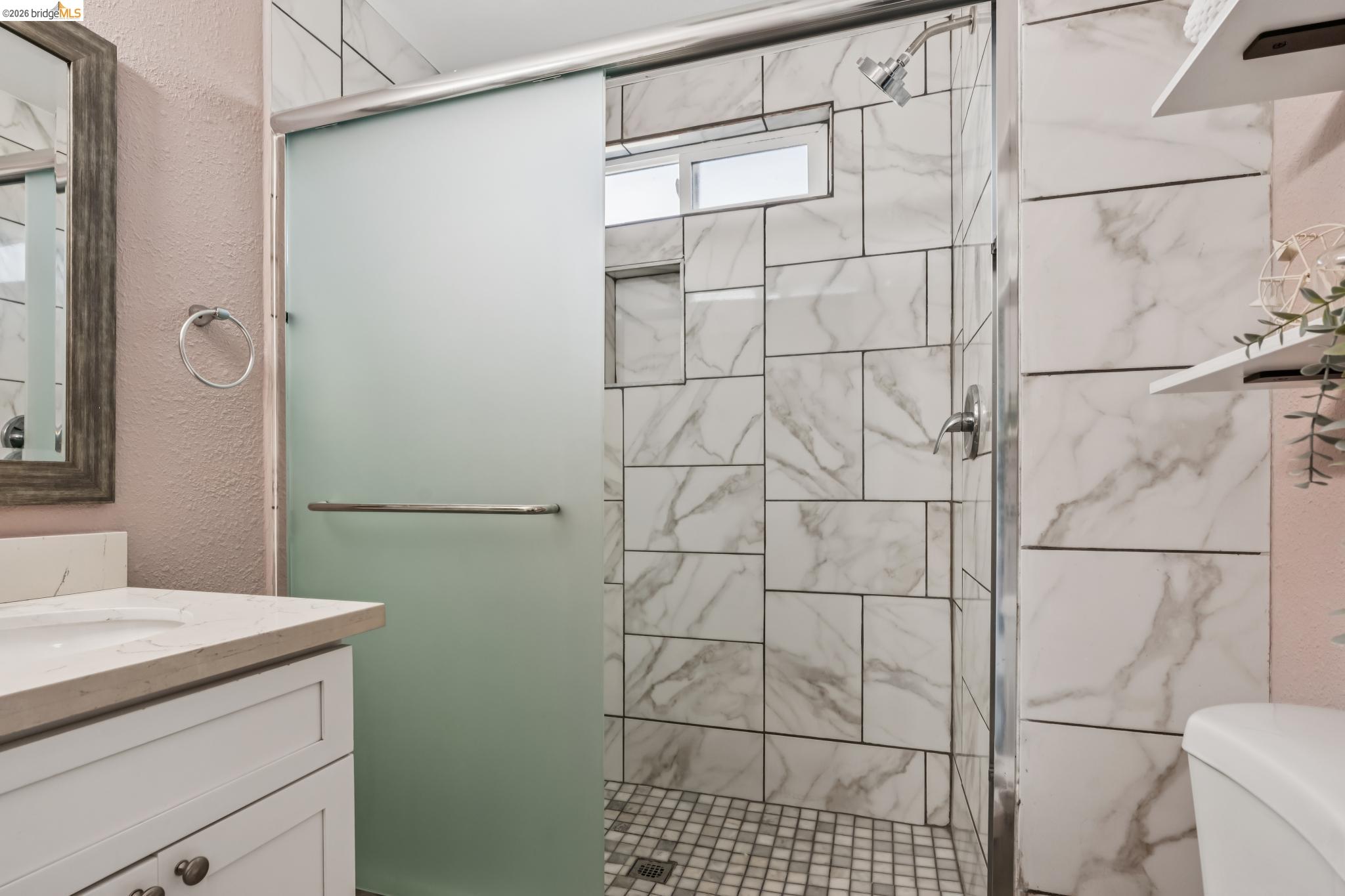 2010 Filbert Street Oakland, CA 94607 - Photo 18 of 50 Full bathroom featuring vanity, a textured wall, and a shower stall