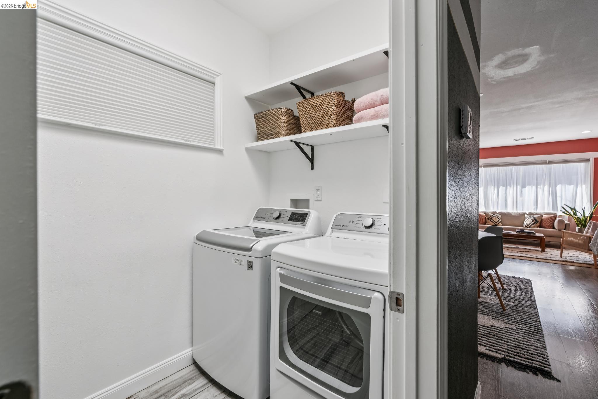2010 Filbert Street Oakland, CA 94607 - Photo 22 of 50 Laundry room with light wood-style flooring and separate washer and dryer