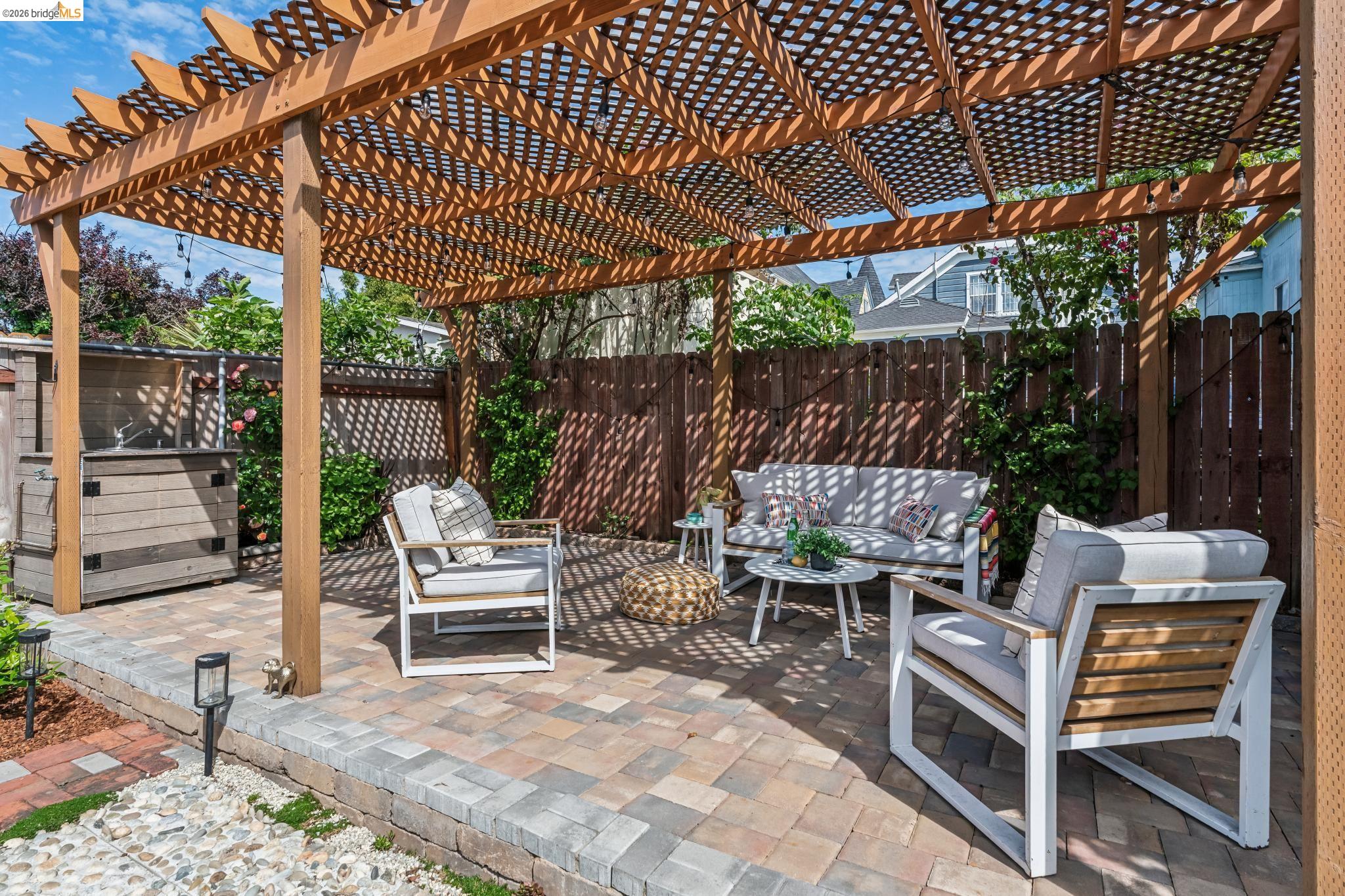 2010 Filbert Street Oakland, CA 94607 - Photo 30 of 50 Fenced backyard with a patio area, a pergola, and an outdoor hangout area