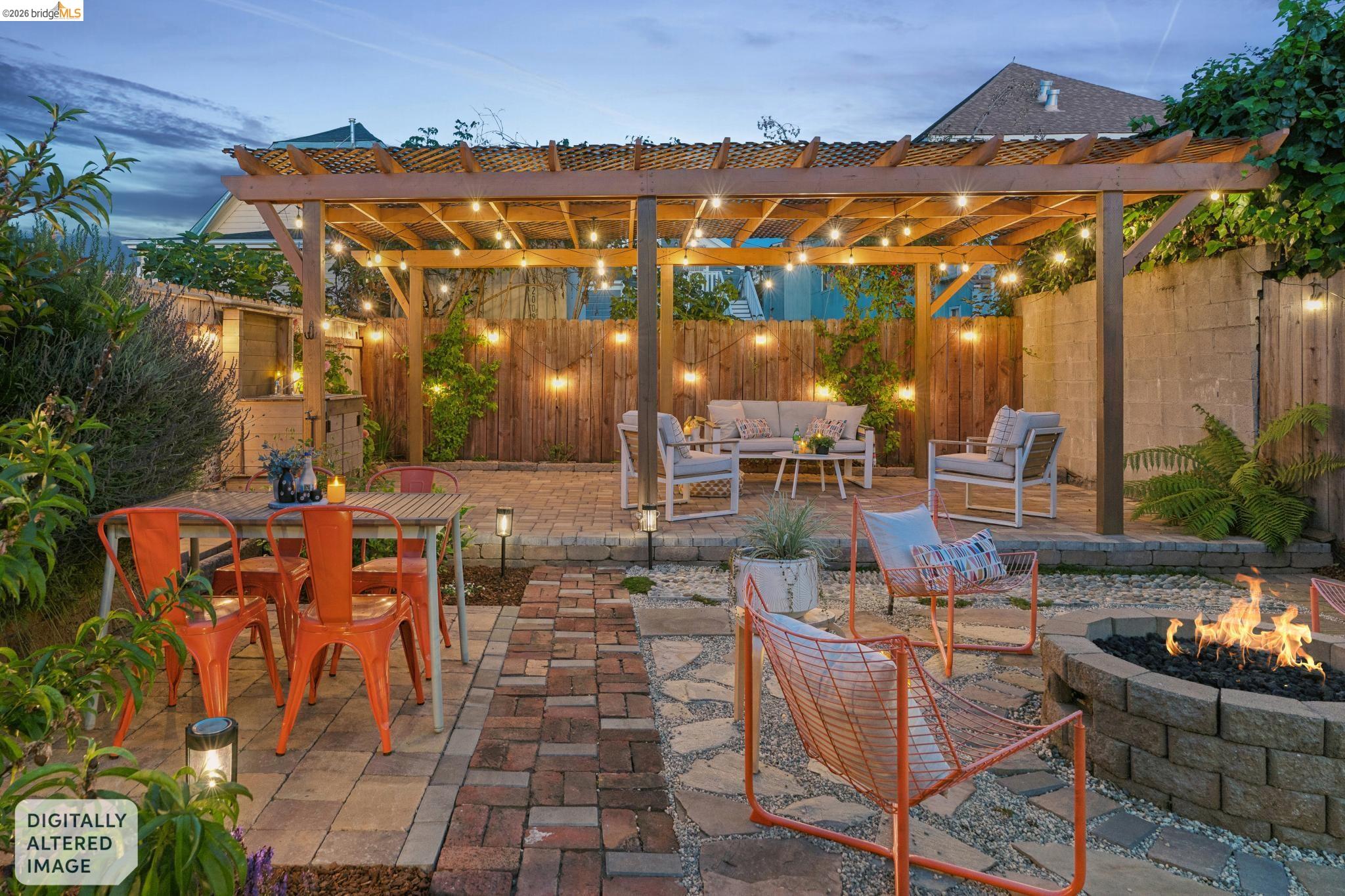 2010 Filbert Street Oakland, CA 94607 - Photo 34 of 50 Fenced backyard with a patio area, a pergola, and an outdoor living space with a fire pit