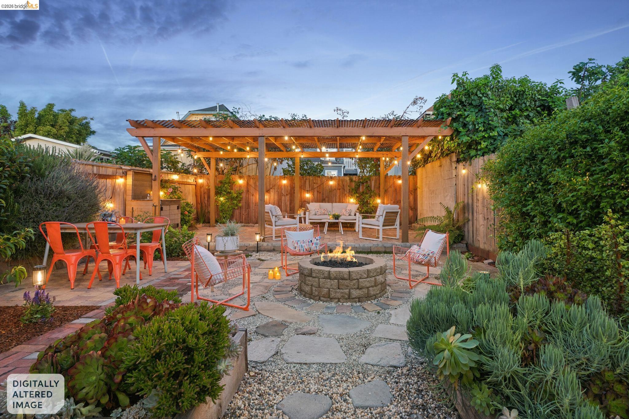 2010 Filbert Street Oakland, CA 94607 - Photo 35 of 50 Patio terrace at dusk with a patio area, a pergola, an outdoor fire pit, a fenced backyard, and an outdoor living / dining area