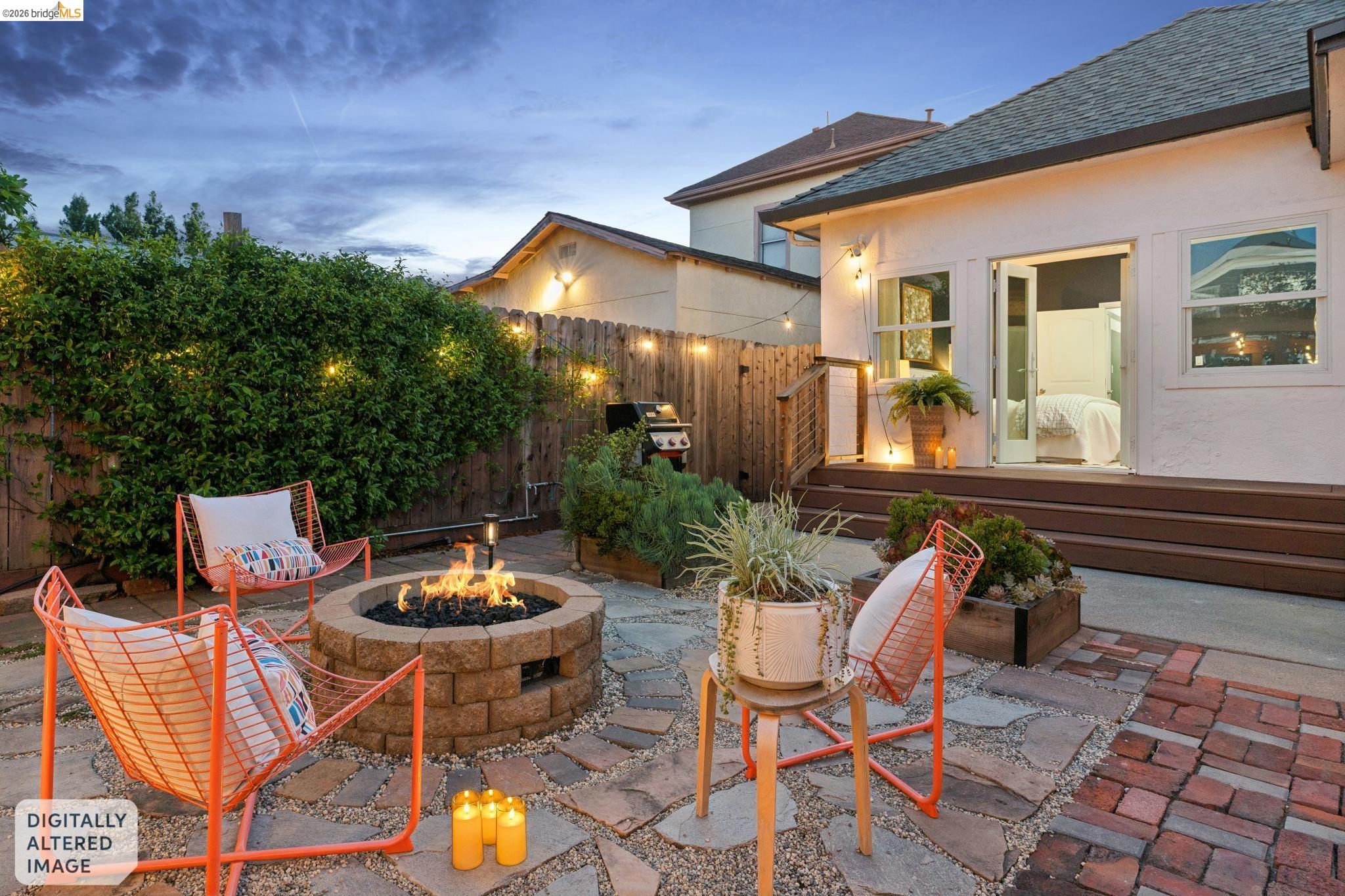 2010 Filbert Street Oakland, CA 94607 - Photo 43 of 50 Patio terrace at dusk with a patio area, a fenced backyard, an outdoor fire pit, and a grill