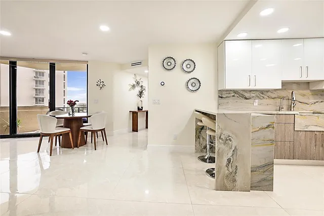 a view of a kitchen with furniture and a living room