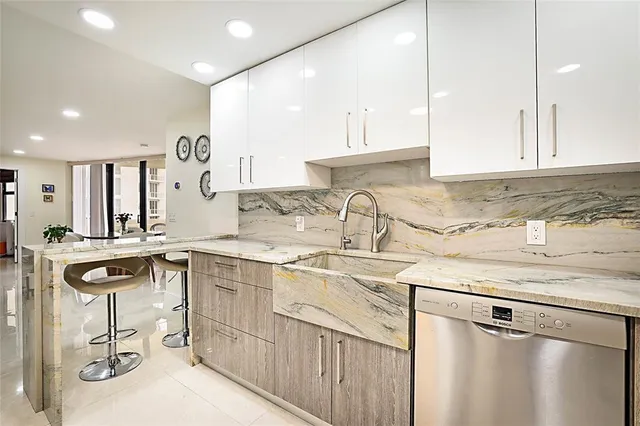 a kitchen with a sink a stove and chairs
