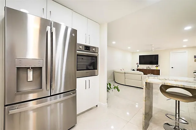 a kitchen with stainless steel appliances a refrigerator and a stove top oven