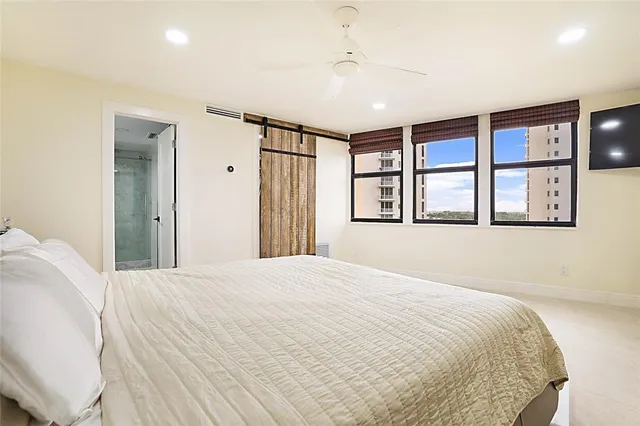 a bedroom with a large bed and a window