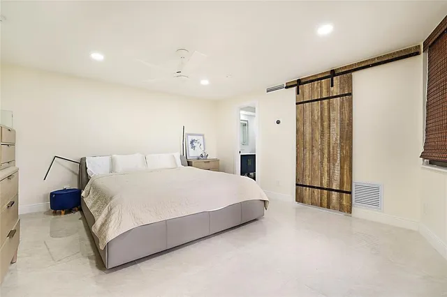 a spacious bedroom with a bed and a walk in closet