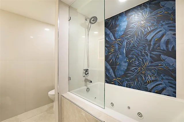 a bathroom with a bathtub and shower