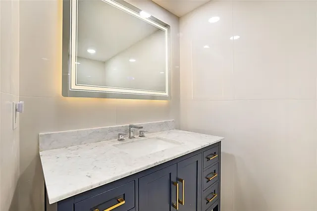 a bathroom with a sink a vanity and a mirror