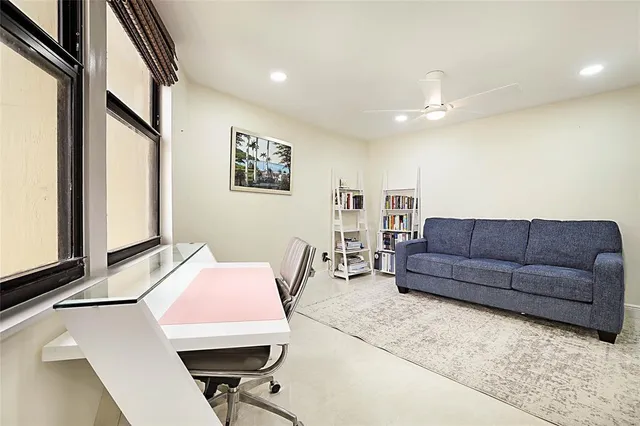 a view of a city from a balcony with seating space