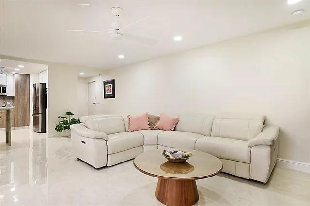 a living room with furniture and a dining table with wooden floor