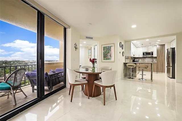 a living room with furniture a flat screen tv and floor to ceiling window