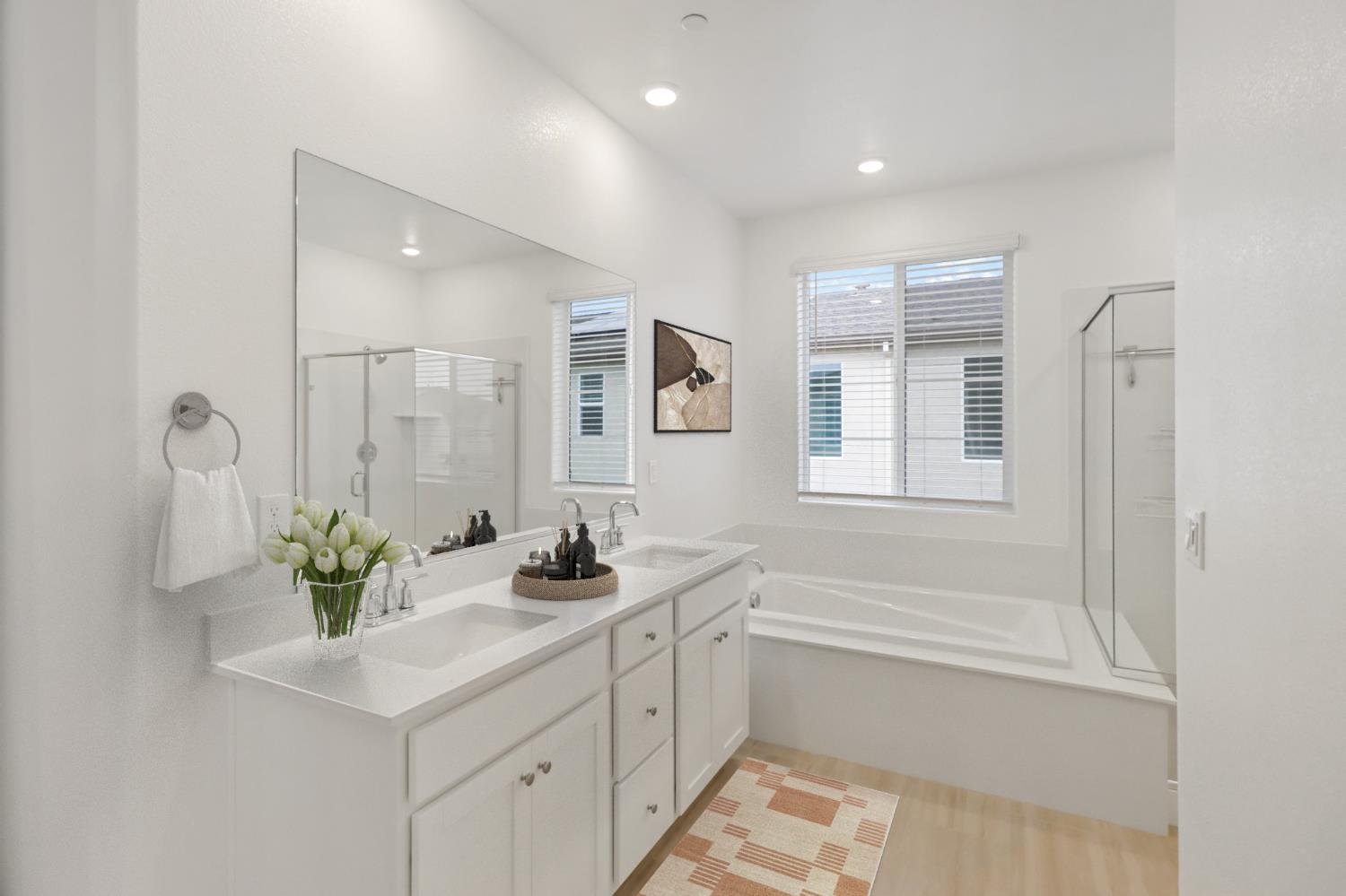 8809 Boes Way Sacramento, CA 95829 - Photo 11 of 40 a bathroom with a double vanity sink and a bathtub