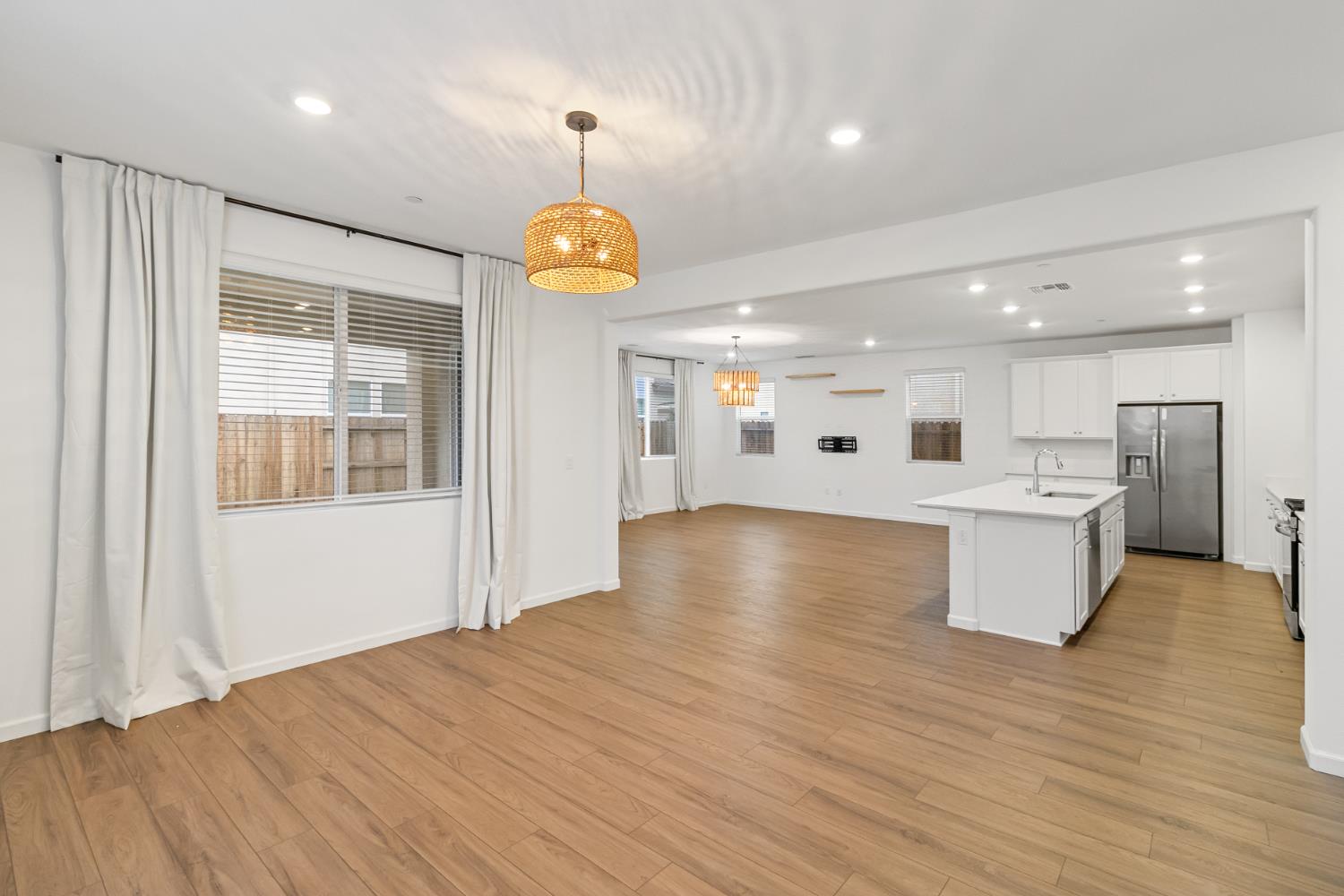 8809 Boes Way Sacramento, CA 95829 - Photo 20 of 40 a view of a kitchen with center island stainless steel appliances wooden floor and window