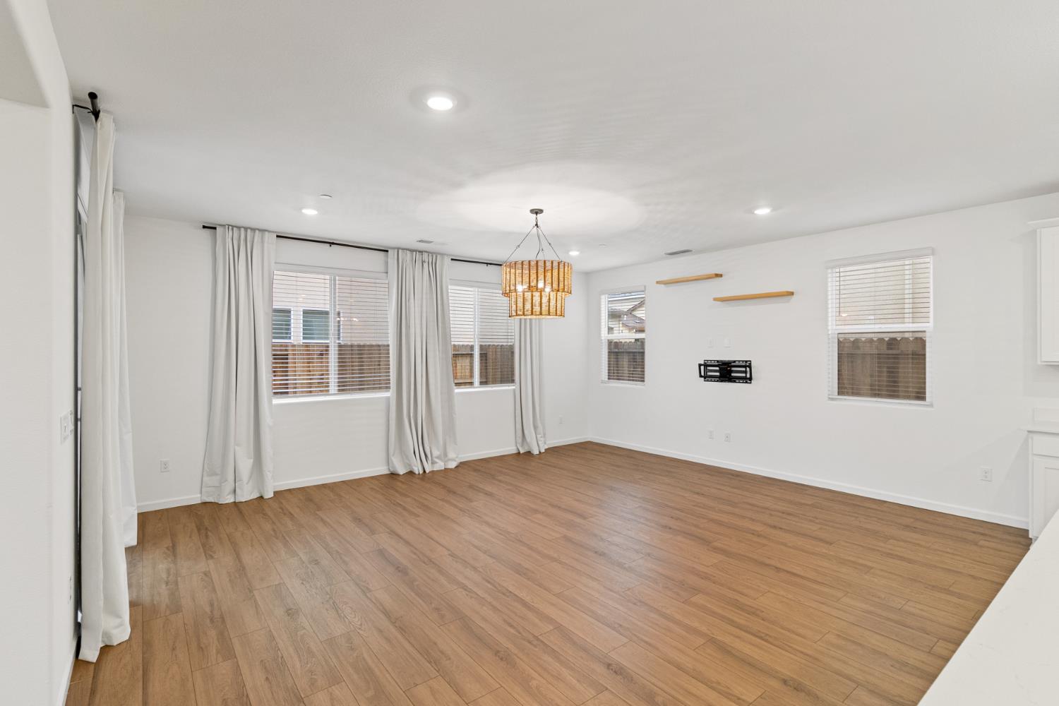 8809 Boes Way Sacramento, CA 95829 - Photo 21 of 40 an empty room with wooden floor and windows
