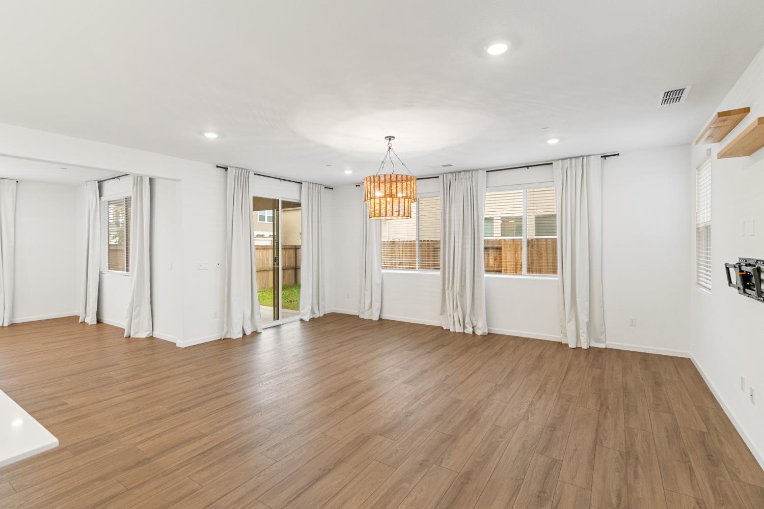 8809 Boes Way Sacramento, CA 95829 - Photo 23 of 40 a view of an empty room with window and wooden floor