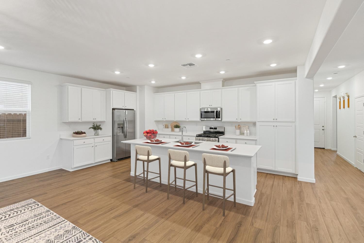8809 Boes Way Sacramento, CA 95829 - Photo 8 of 40 a kitchen with a sink a stove a refrigerator and white cabinets with wooden floor