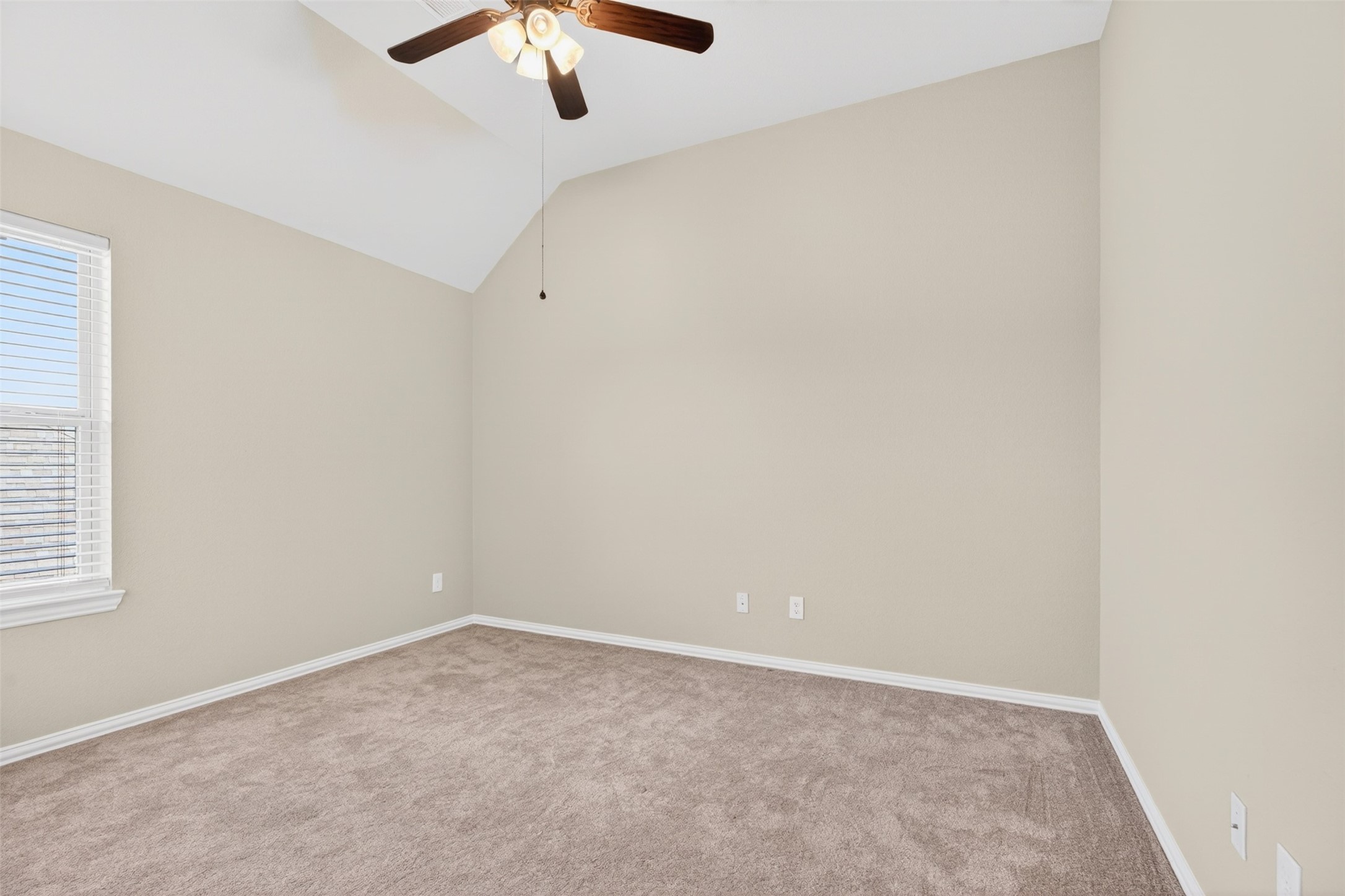 18202 Wedgewood Bluff Court Spring, TX 77379 - Photo 42 of 50 Secondary bedroom angle with ceiling fan, window, and carpet flooring.