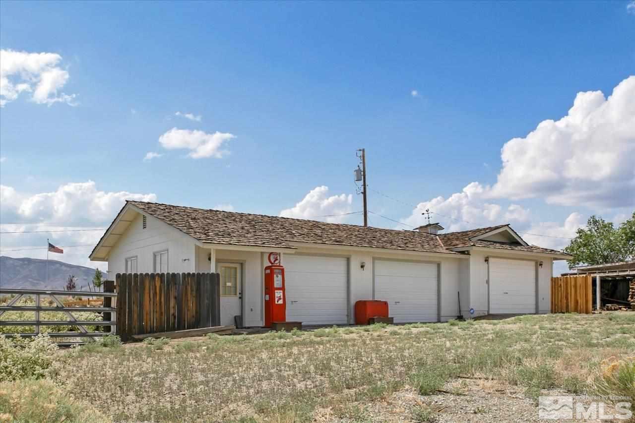 10200 Placerville Road Reno, NV 89508 - Photo 5 of 31 a front view of a house with a yard and garage
