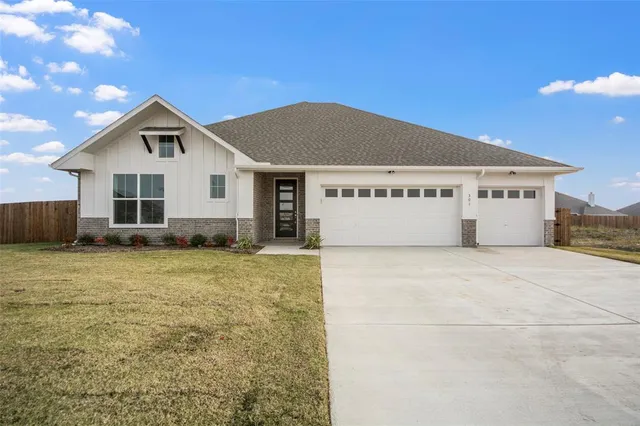 a view of a house with a yard and garage