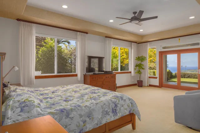 a bathroom with a granite countertop sink a large mirror and a bathtub