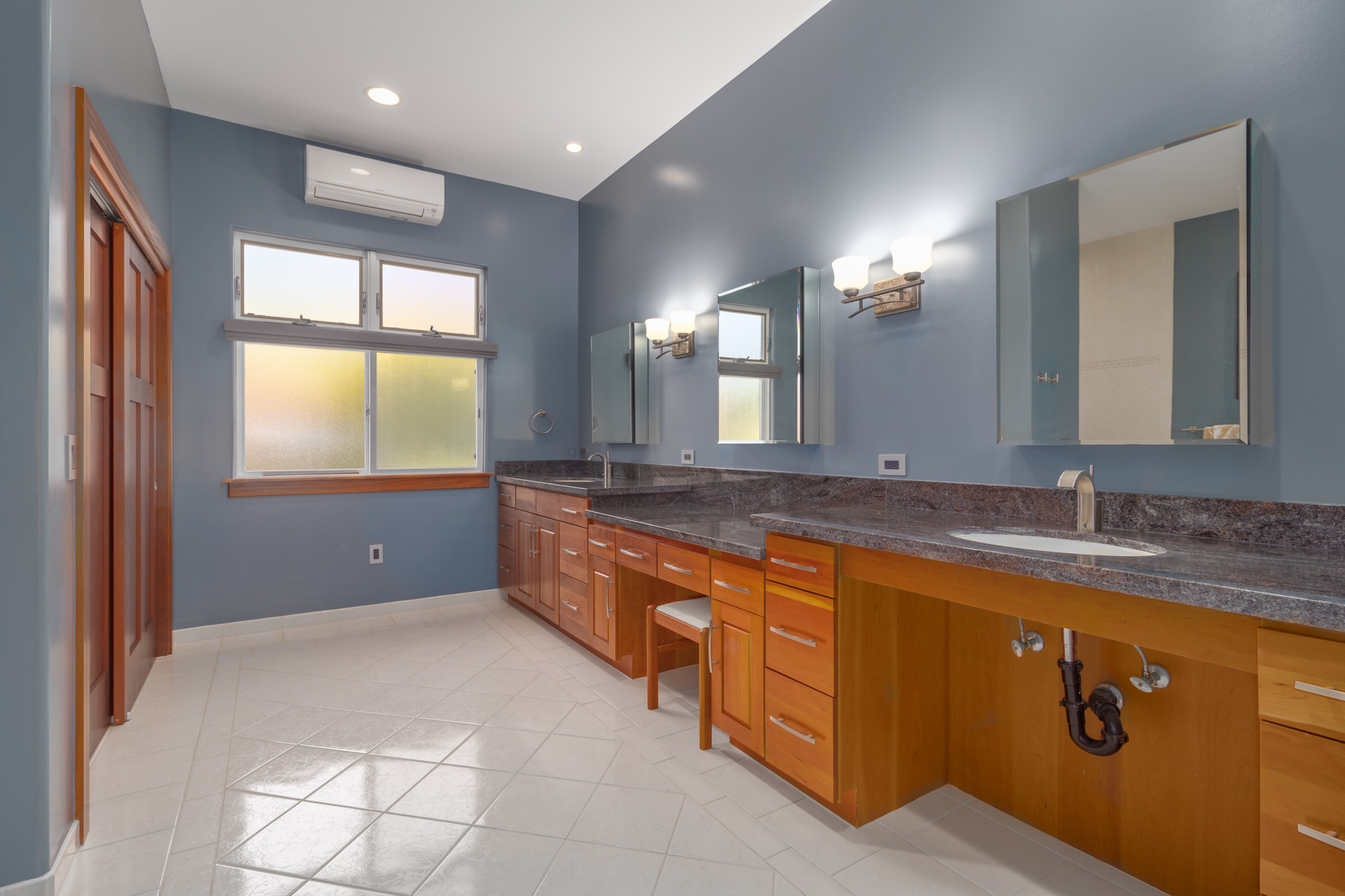82-1171 Meli Road Captain Cook, HI 96704 - Photo 15 of 29 a bathroom with a granite countertop sink a large mirror and a bathtub