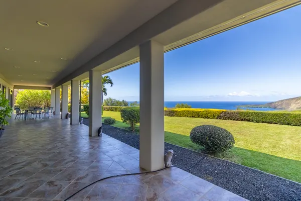 a view of a house with backyard porch and sitting area