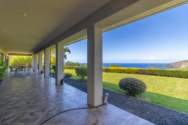 a view of a house with backyard porch and sitting area
