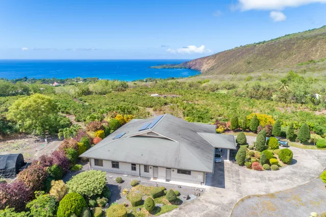 an aerial view of a house with big yard