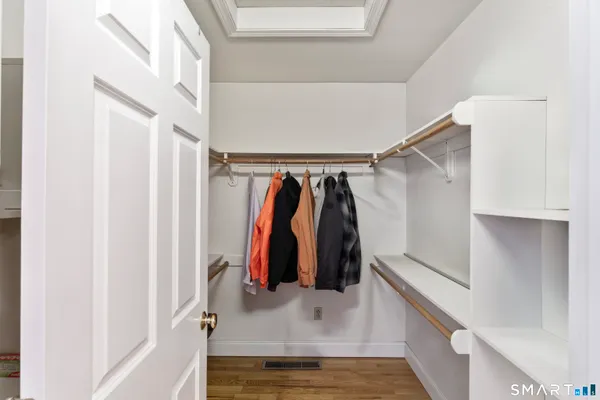 a bedroom with a bed with wooden floor