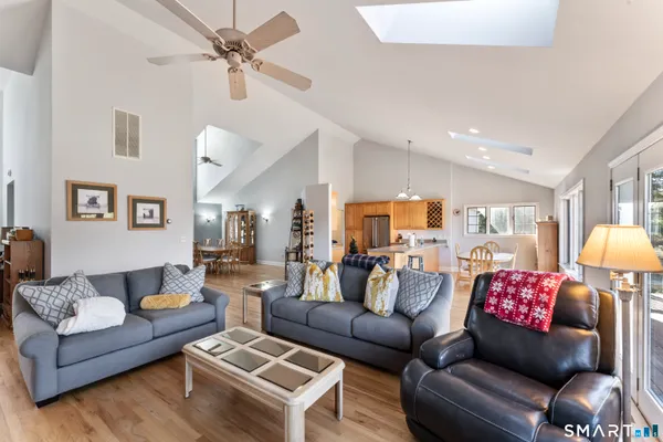 a living room with furniture and kitchen view
