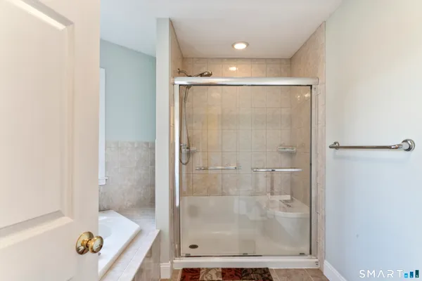 a bathroom with a glass shower door