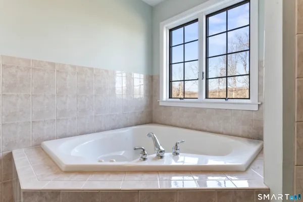 a bath tub sitting in a bathroom next to a window